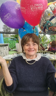 From nursing to patient safety and preparing for disasters 1 A woman sits at a table surrounded by balloons with the message, happy retirement.