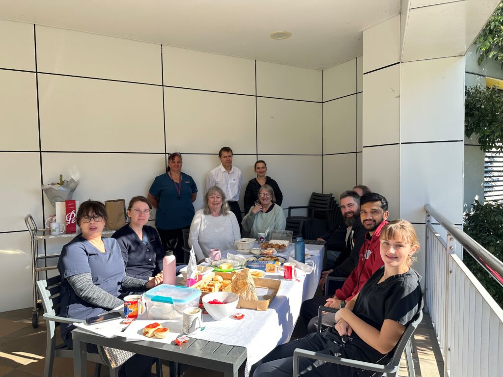 Deb’s ‘independence day' as she retires after 50 years of service 2 People sitting around a table etting morning tea in the sun