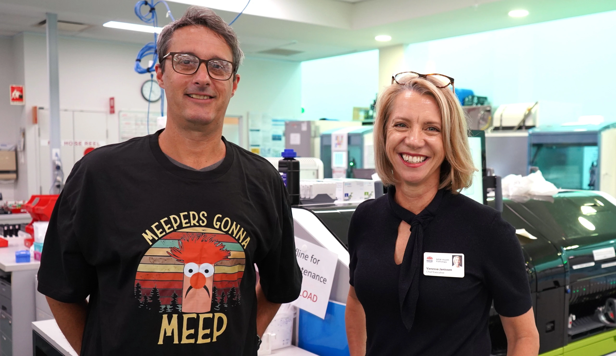A man and a woman smiling in a laboratory.