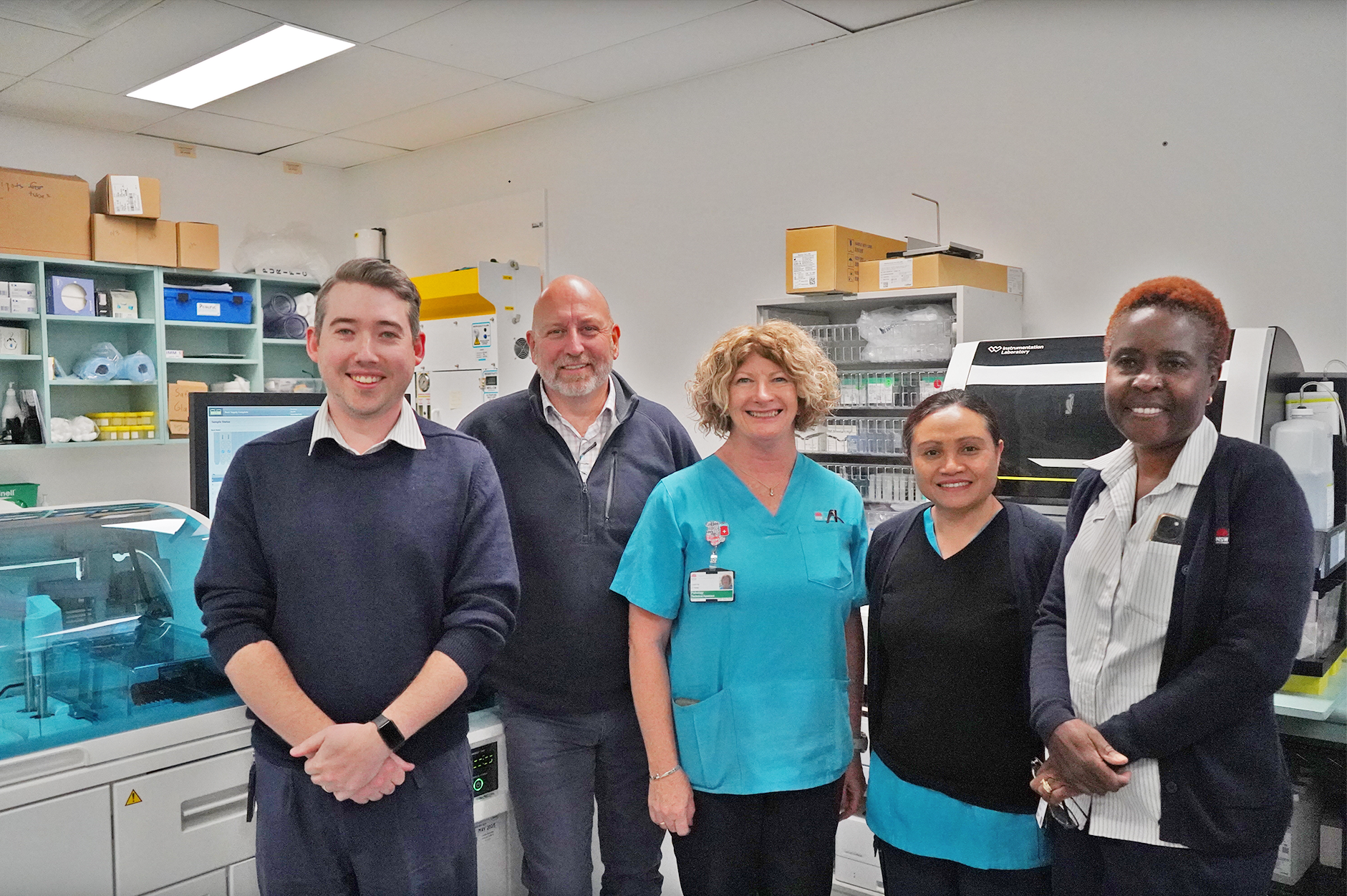 A group of four people in a laboratory.